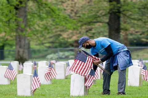 Duke Energy volunteers place flags in the cemetery of the Indiana Veterans’ Home