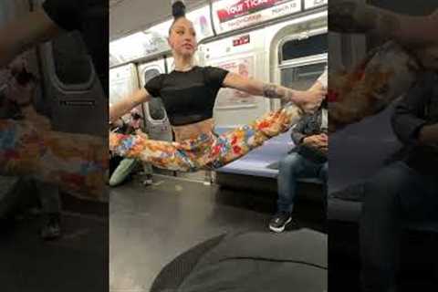Woman hangs on handle with hair in NYC