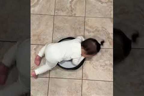 Baby takes a ride on roomba vacuum