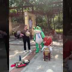 Mascot Frog Dances With Elderly Folk Band